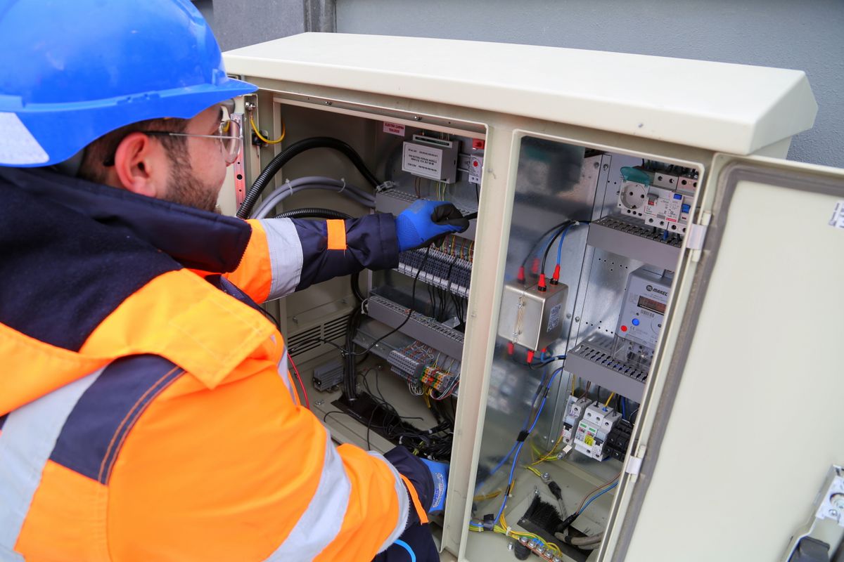 Licensed electrician servicing an electrical panel